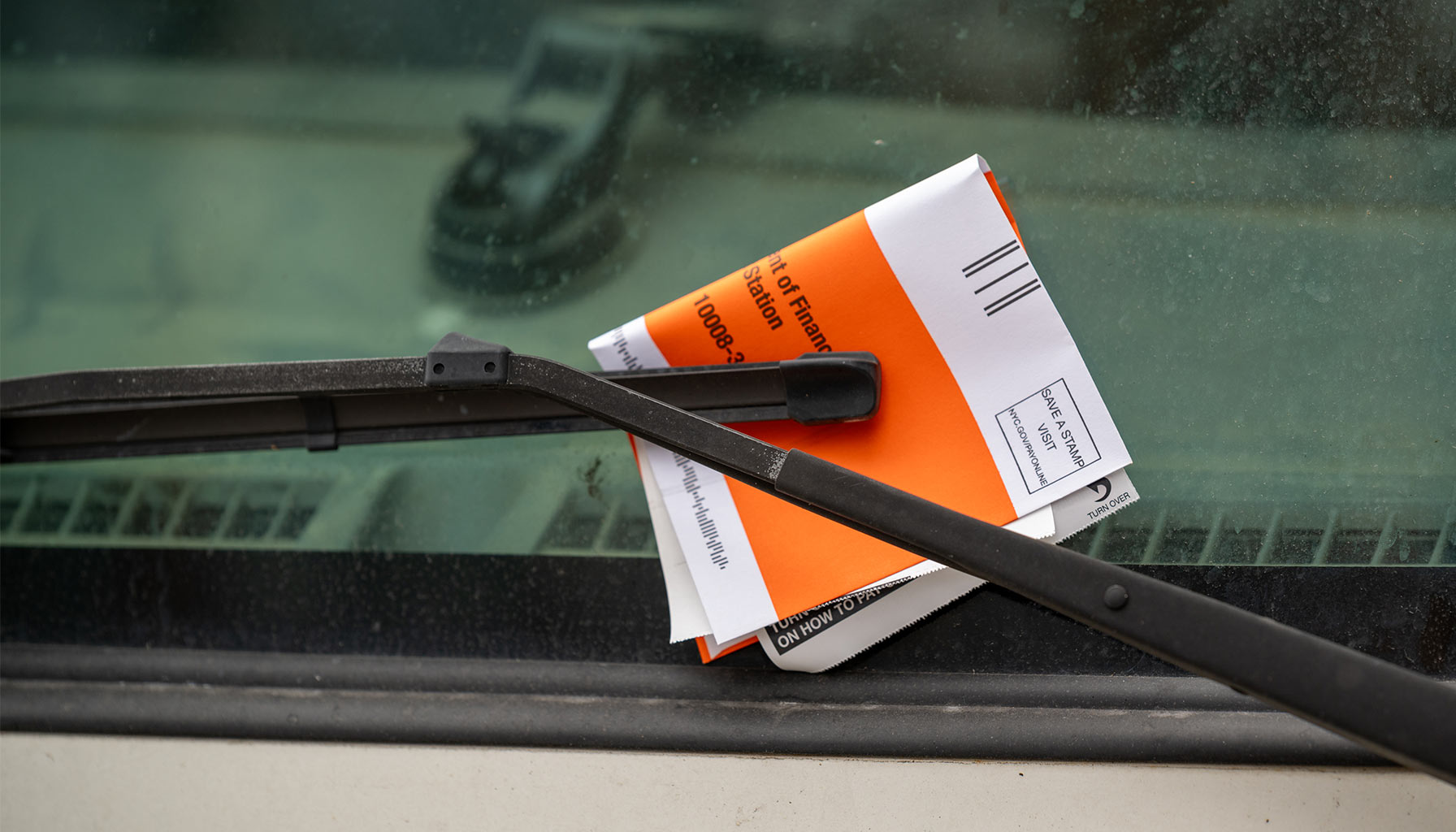 NYC parking ticket under van's windshield
